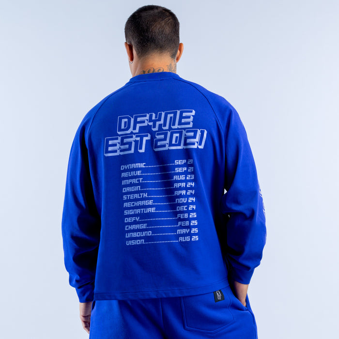 Blue long sleeve top with back white DEFY EST. 2021 print and date list