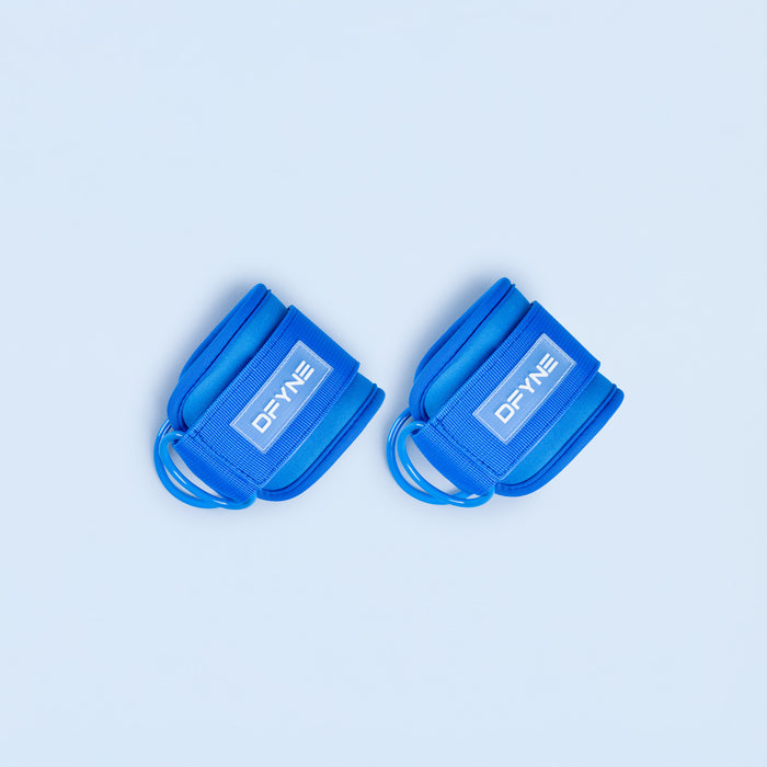 Blue ankle straps with DYNY logo patch and adjustable loop closures