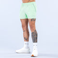 Mint green 4-inch training shorts with elastic waistband and drawstring