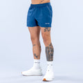 Men's blue training shorts with elastic waistband and small side logo