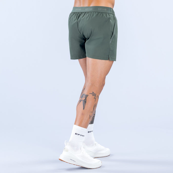 Dark green training shorts, back view with elastic waistband and roomy fit