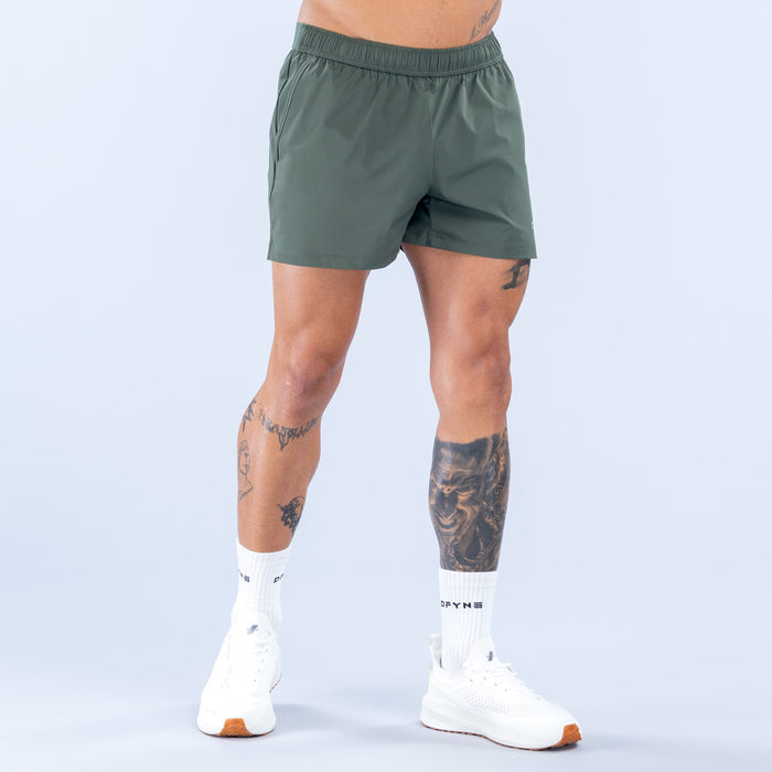 Dark green training shorts with elastic waistband and subtle front shaping