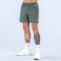 Dark green 6-inch training shorts with elastic waistband and small side logo.