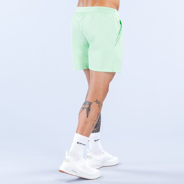 Light green training shorts, rear view with elastic waistband and 6-inch inseam