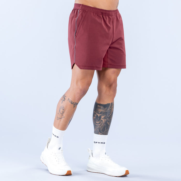 Maroon training shorts with straight hem, elastic waist, and side stripe