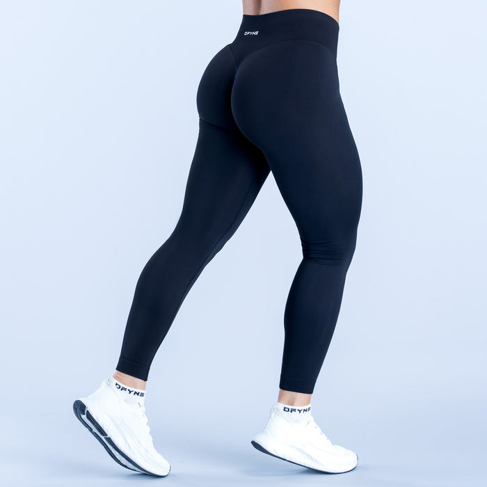 Dark performance leggings with contoured back panels and ankle-length fit