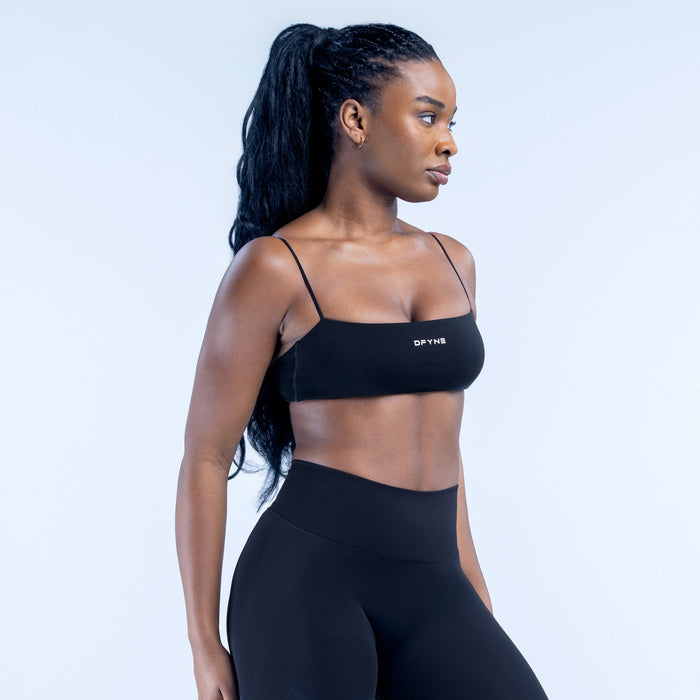 Black strappy bralette with thin spaghetti straps and DYNE logo on front