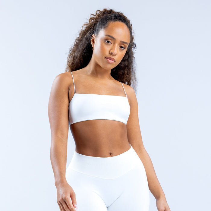 White strappy bra with thin straps and smooth cups, front view.