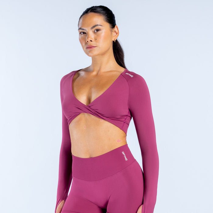 Twist-front long sleeve athletic top in deep plum with V-neck and crossover chest seam