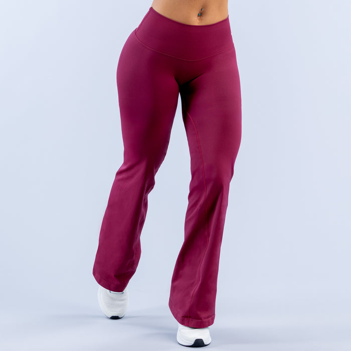 Burgundy high-rise bootcut leggings with smooth, fitted front