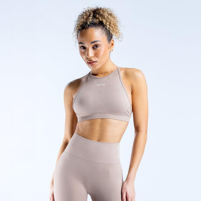 Taupe high neck backless sports bra with racer-style front and strappy back
