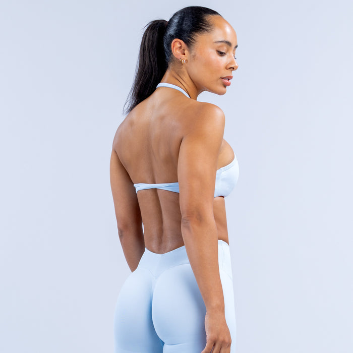 Light blue high-neck halter bra from back view, slim halter straps