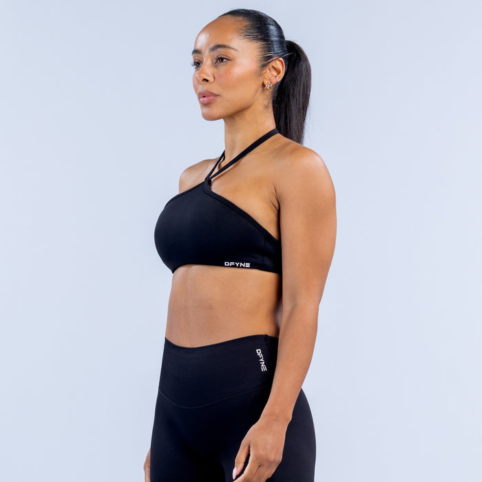 Dark high-neck halter sports bra with thin crisscross halter straps