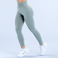 Teal high-rise leggings with smooth, figure-hugging fit and subtle logo at waistband