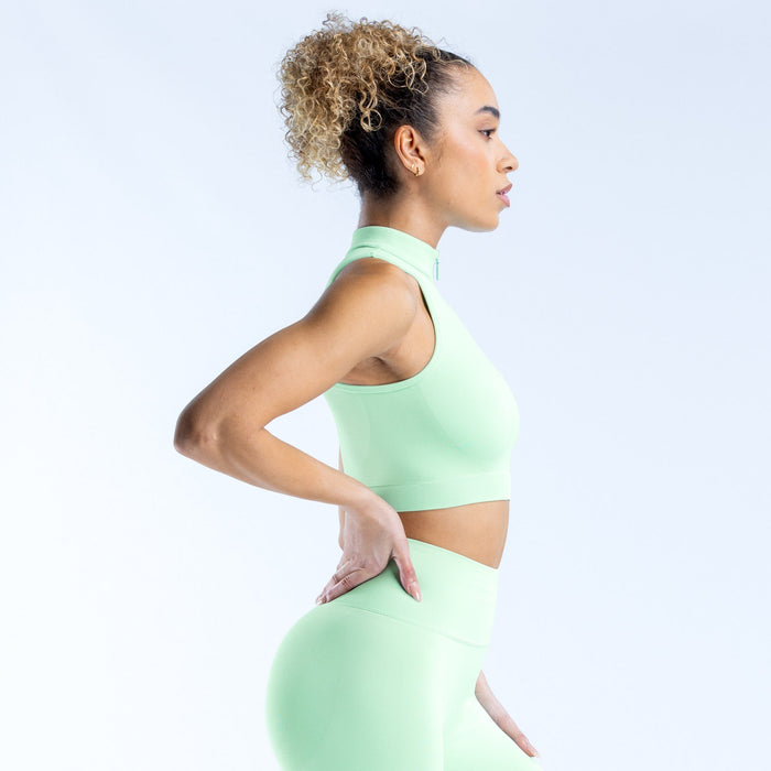 Sleeveless quarter-zip tank in mint green, cropped high neck with half-front zipper