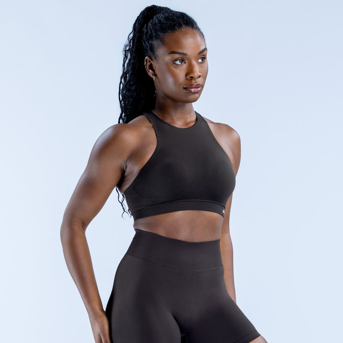 Black racerback sports bra with high neckline and smooth cropped bust