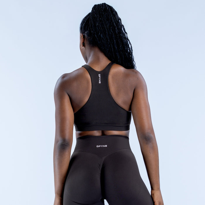 Black racerback sports bra with open back and center logo detail