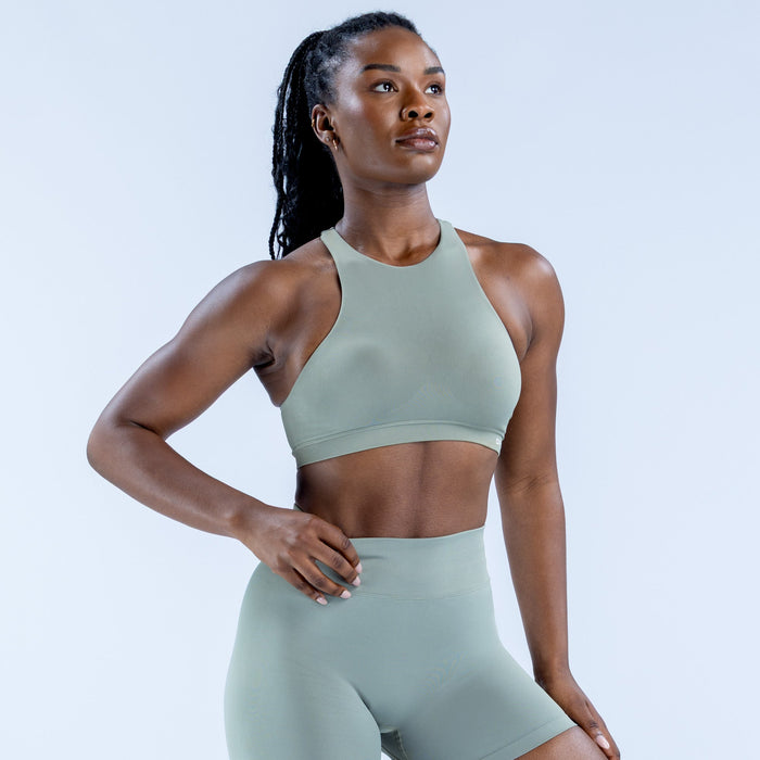 Sage green high-neck racerback sports bra with smooth fitted look