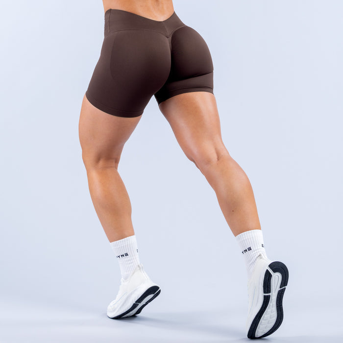 Mid-thigh athletic shorts, dark brown, slim fit with contoured back and side seams