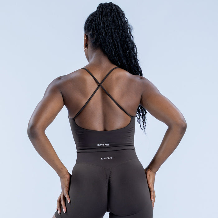 Black strappy sports top with crossed-back straps and open back design