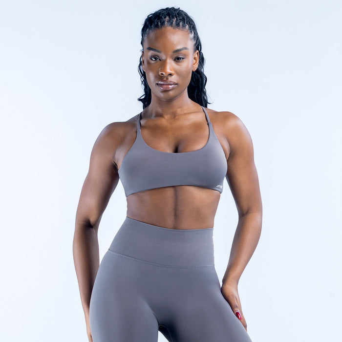 Dark gray sports bra with racer-back straps and front scoop neckline
