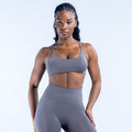 Dark gray sports bra with racer-back straps and front scoop neckline