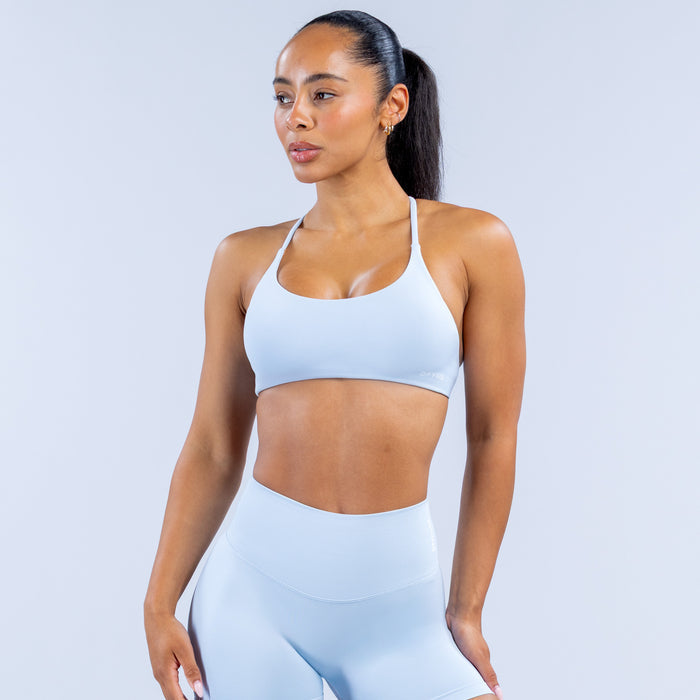 Light blue seamless sports bra with scoop front and thin shoulder straps