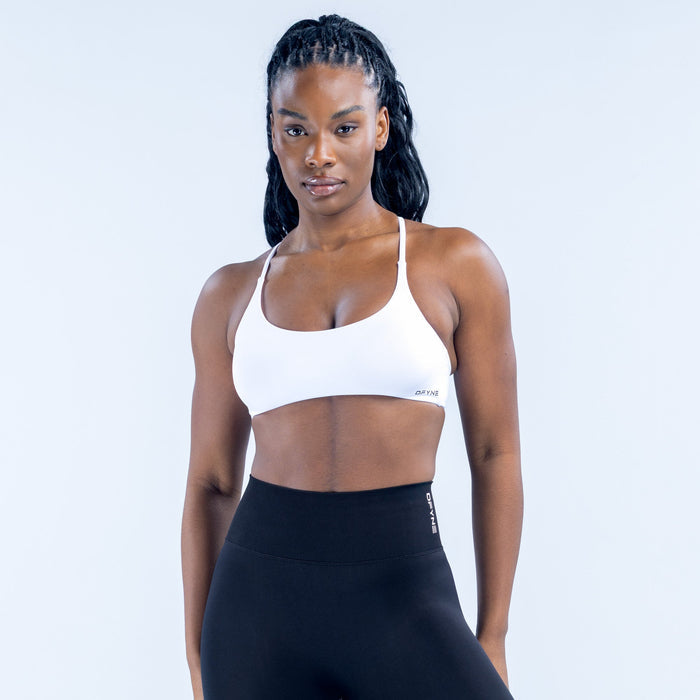 White twist-back sports bra with thin straps and scoop front