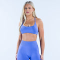 Blue sports bra with twist back straps and racerback front.