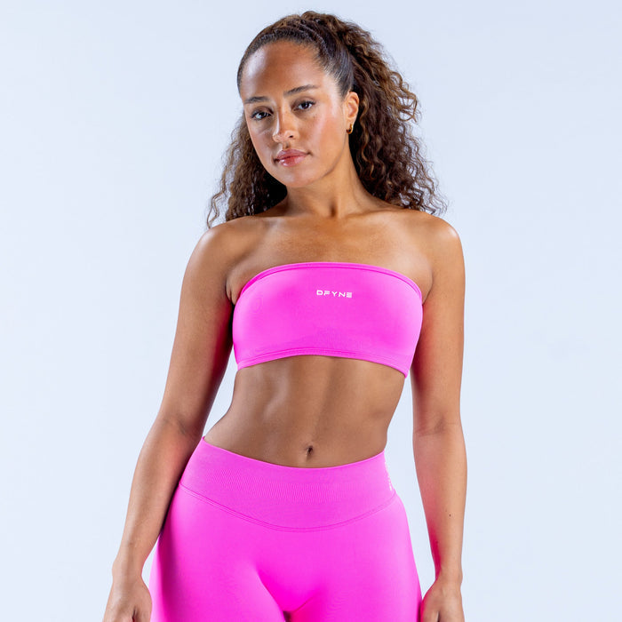 Hot pink bandeau top and high-waist leggings with smooth, stretchy fabric.