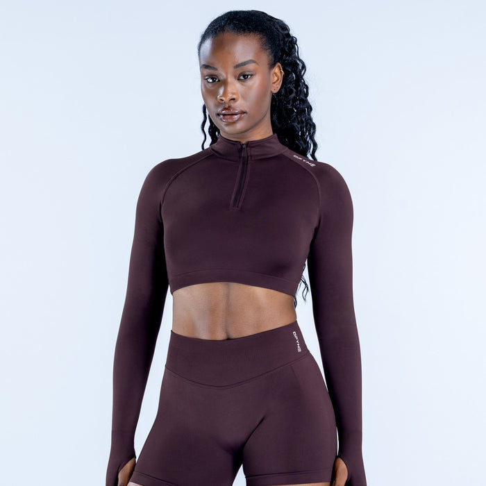 Maroon impact crop jacket with quarter zip and long sleeves, fitted athletic top