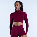 Burgundy long-sleeve zip-front crop top, high neckline, fitted athletic fabric