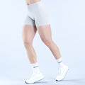 Light blue athletic impact shorts, side view with elastic waistband and smooth leg openings
