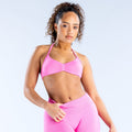Pink strappy sports bra with ruched center and adjustable thin straps