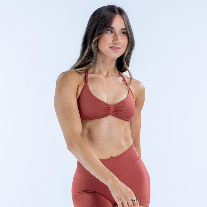 Strappy bra in rust red with ruched cups and thin shoulder straps
