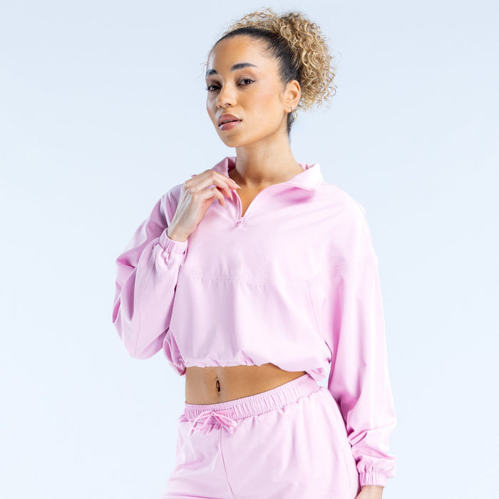 Pink cropped zip jacket front view with half-zip, elastic cuffs, and drawstring hem