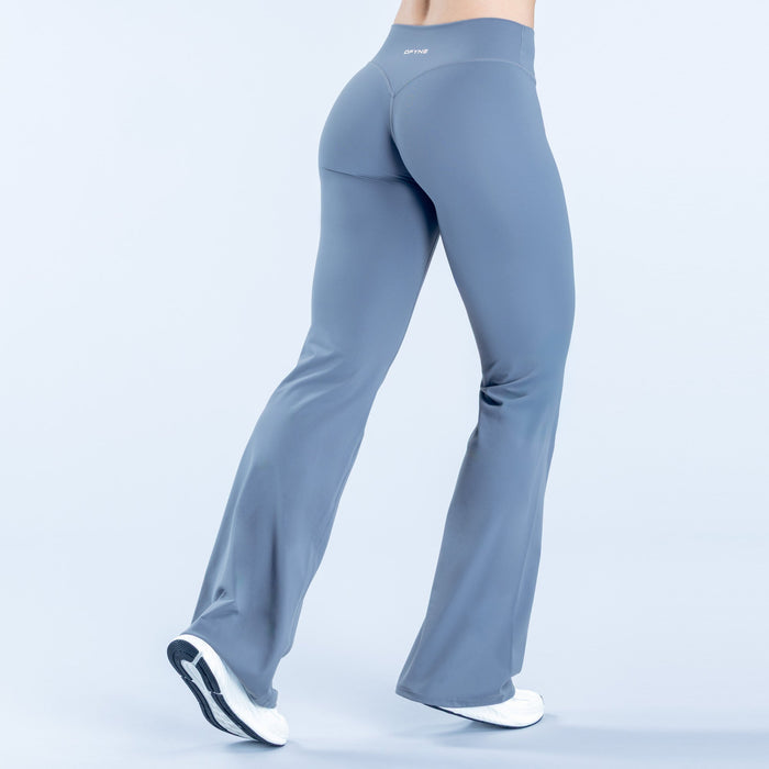 Women's blue flared leggings, back view, smooth fit and curved seam lines