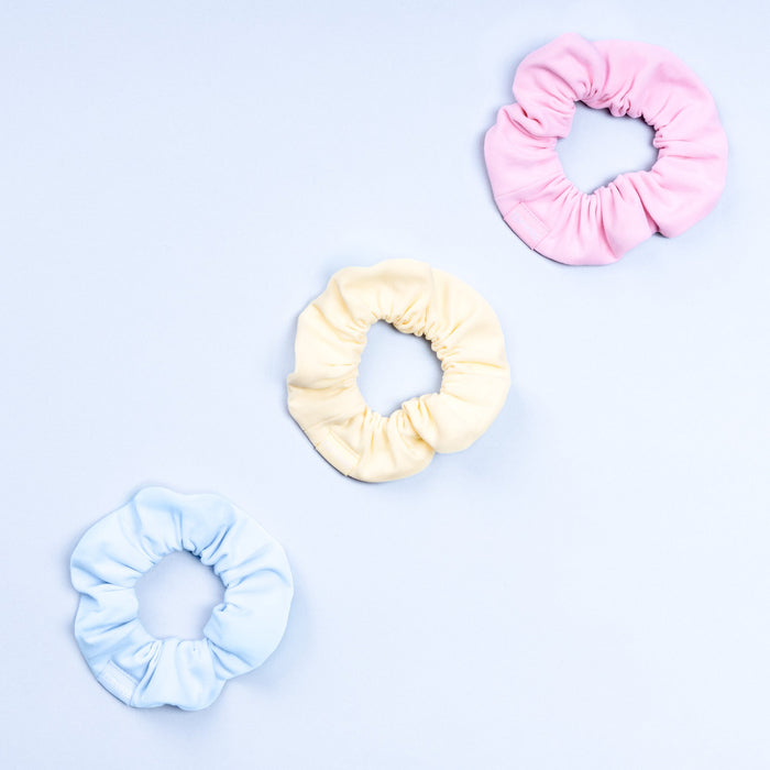 3-pack scrunchies in light pink, cream, and light blue with gathered elastic