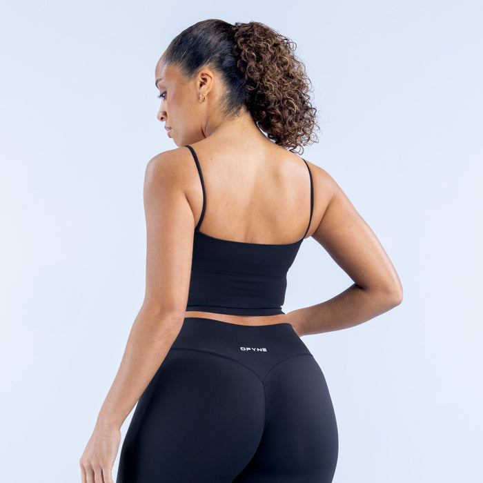 Black strappy sports crop top showing the back with thin straps