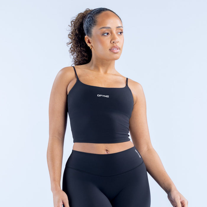 Black strappy crop top with square neckline, thin straps, and small chest logo