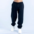 Dark navy joggers with elastic waistband, cuffed ankle hems, and side pockets.
