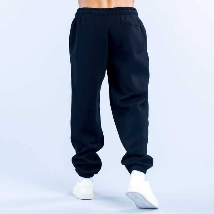 Dark navy joggers with elastic waist, cuffed hems, and a back pocket detail.