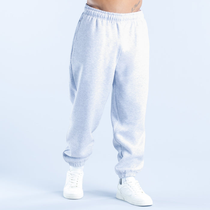 Light blue joggers with elastic waistband and ribbed cuffs, relaxed tapered fit