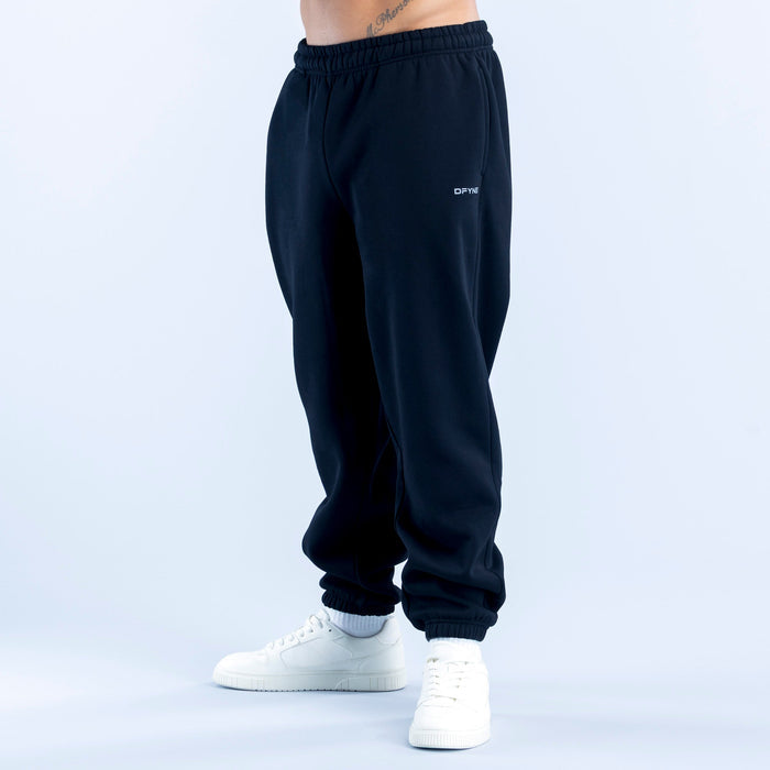 Dark navy joggers with elastic waist, cuffed hems, and small thigh logo.