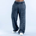 Washed jogger pants in dark navy with elastic waistband and graphic side print