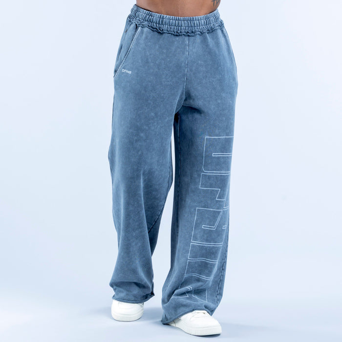 Washed jogger pants in blue wash with elastic waistband and large vertical line-art graphic