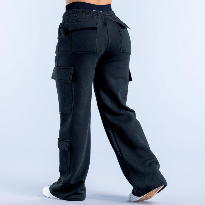 Black cargo jogger pants, back view with flap pockets and elastic waistband.