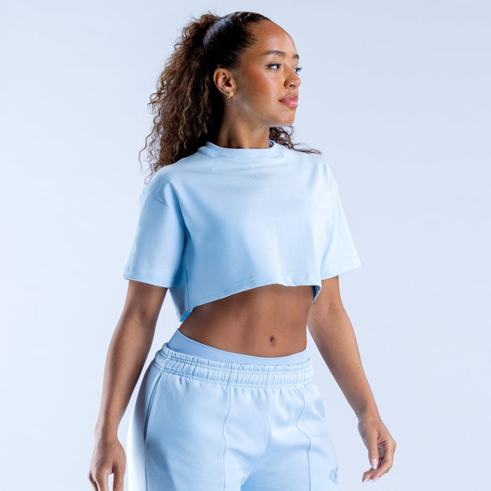 Light blue cropped crew-neck tee with short sleeves, angled view