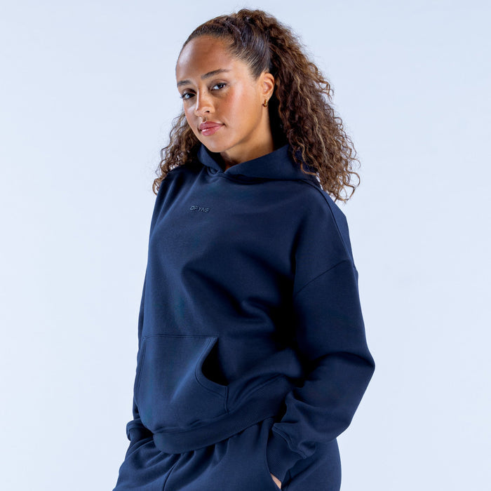 Dark navy pullover hoodie with hood and kangaroo pocket, side profile