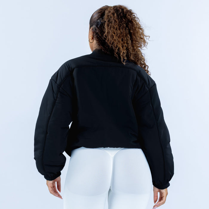 Black reversible bomber jacket, back view with full sleeves and ribbed hem